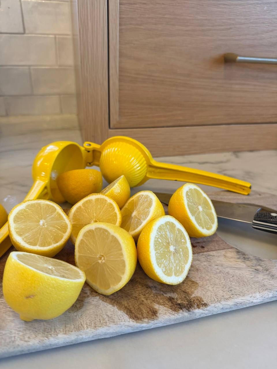 Halved lemons and the citrus press