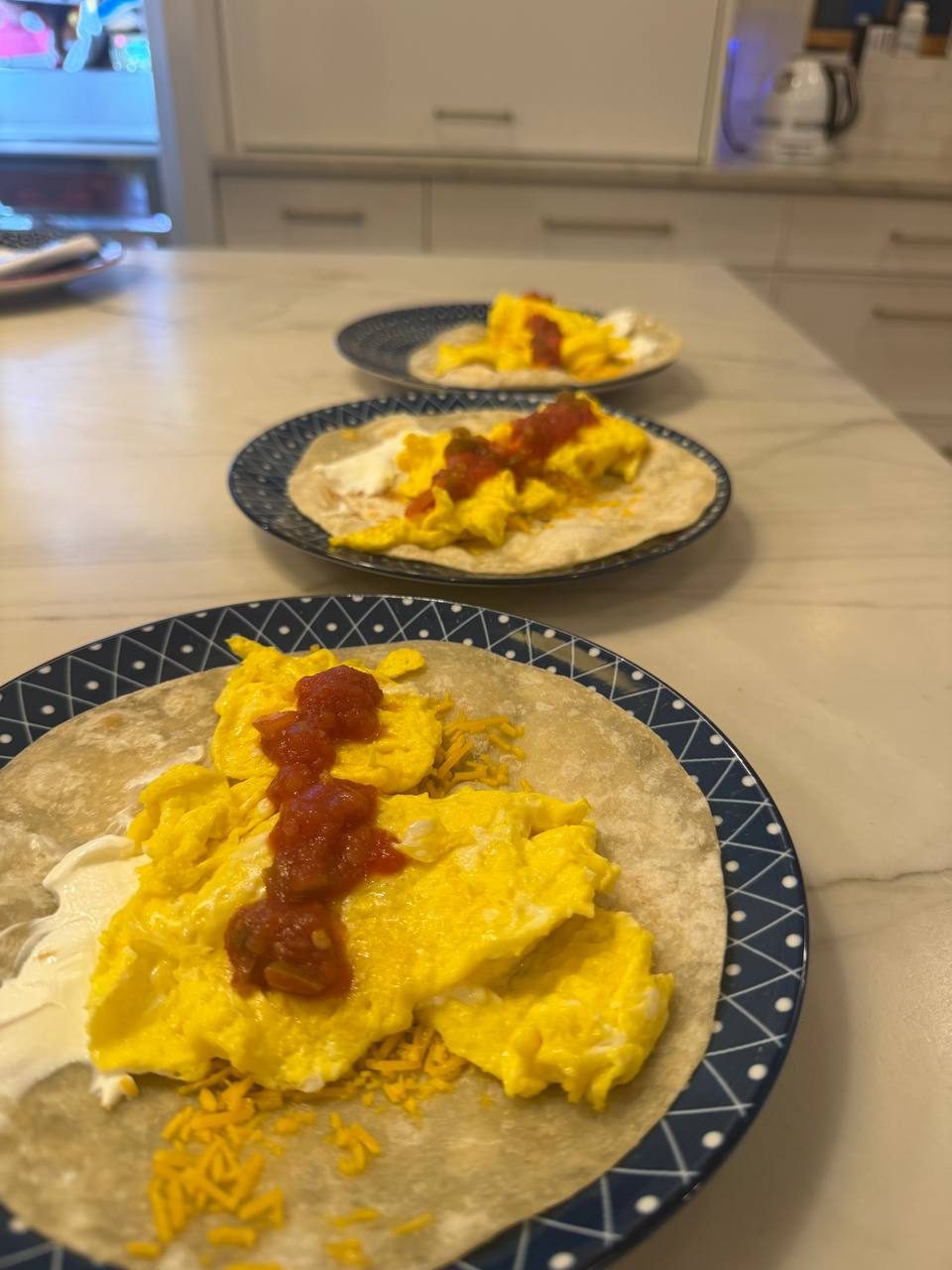 Soft scrambled eggs with salsa on flour tortillas